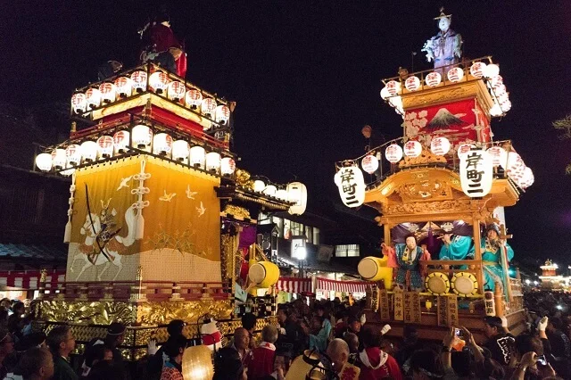 Lantern-lit Kawagoe Festival float moving through the historic warehouse district at night