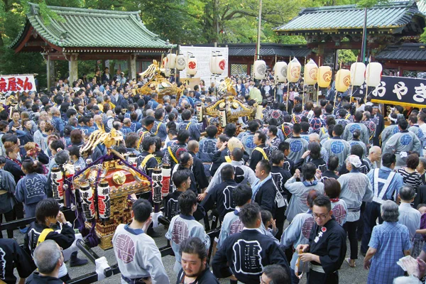 Multiple mikoshi and festival crowds inside Nezu Shrine during the Reitaisai weekend