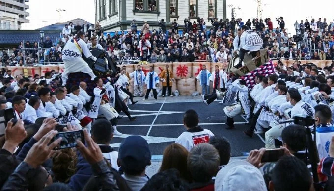 Crowds watching mikoshi hachiawase near Dogo Onsen Station during the autumn festival