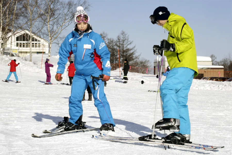 Beginner ski lesson in Sapporo. Instructor time is only one part of first-day cost; equipment sizing, outerwear, protective gear, check-in and lift access all affect the real total.