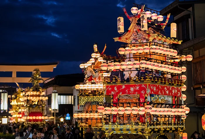 Takayama Autumn Festival evening street scene with illuminated traditional floats