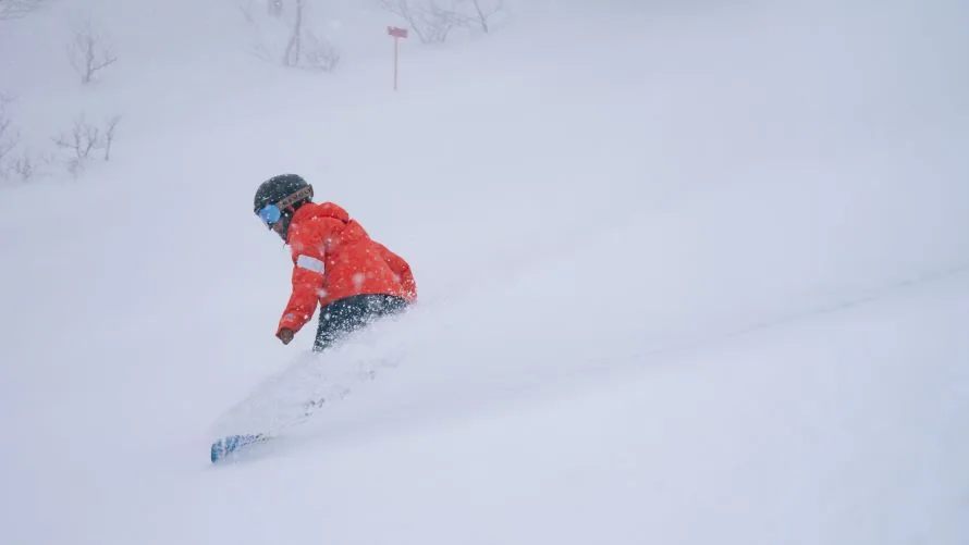Skiers outside Shin Furano Prince Hotel showing Furano Zone ski-in ski-out access