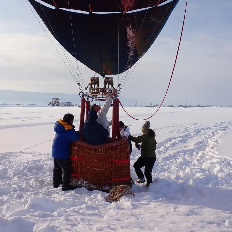 Winter Furano hot air balloon Free Flight preparing for takeoff. Without tether lines, the route is determined by wind direction at different altitudes.