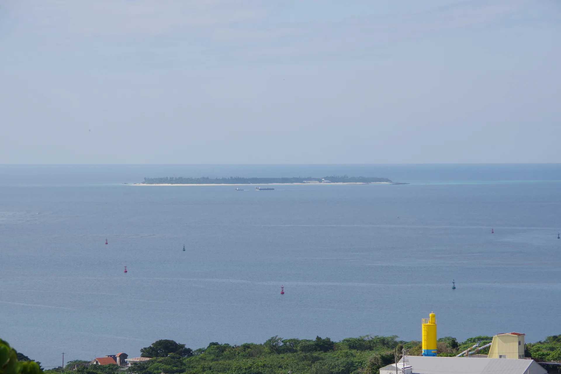 View toward Minna Island from Okinawa Main Island. Ferry timing and a Motobu base can matter as much as the activity package itself.
