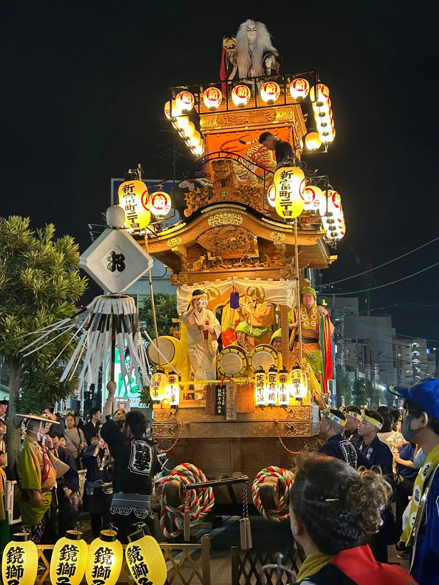 Close view of a Kawagoe Festival float showing lanterns, carving and musicians