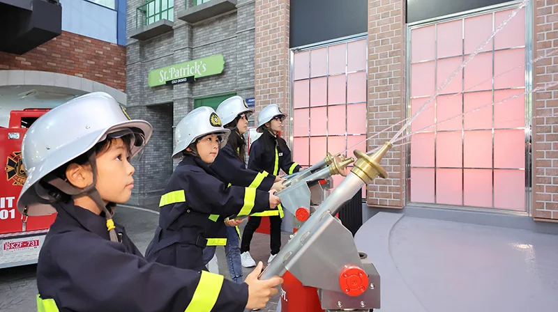 Children taking part in the firefighter activity at KidZania Fukuoka