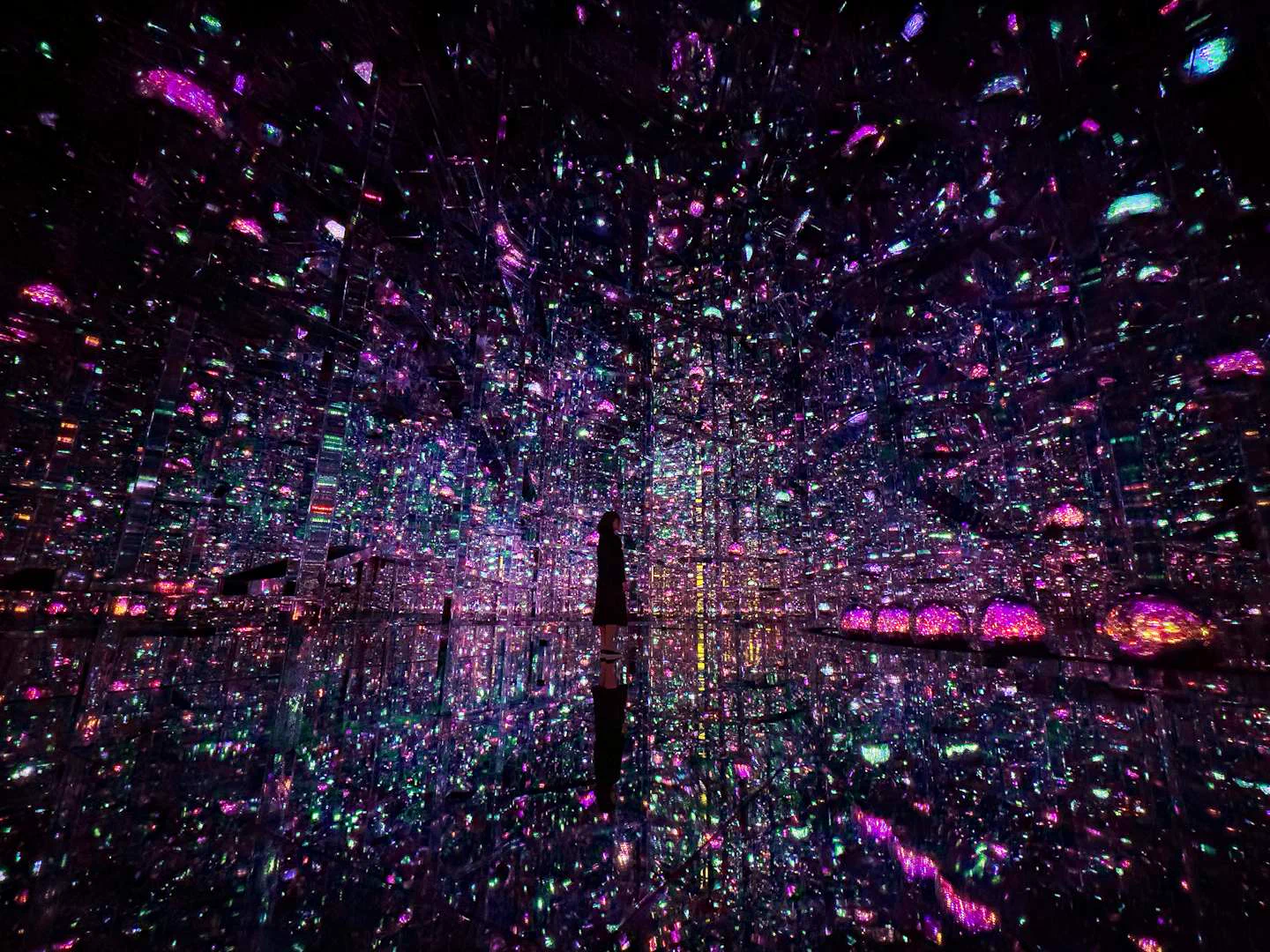 Infinite Crystal World at teamLab Borderless with mirrored reflections and countless colored light points