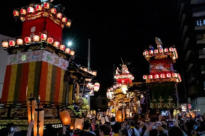 Multiple lantern-lit floats meeting at night during Kawagoe Festival hikkawase