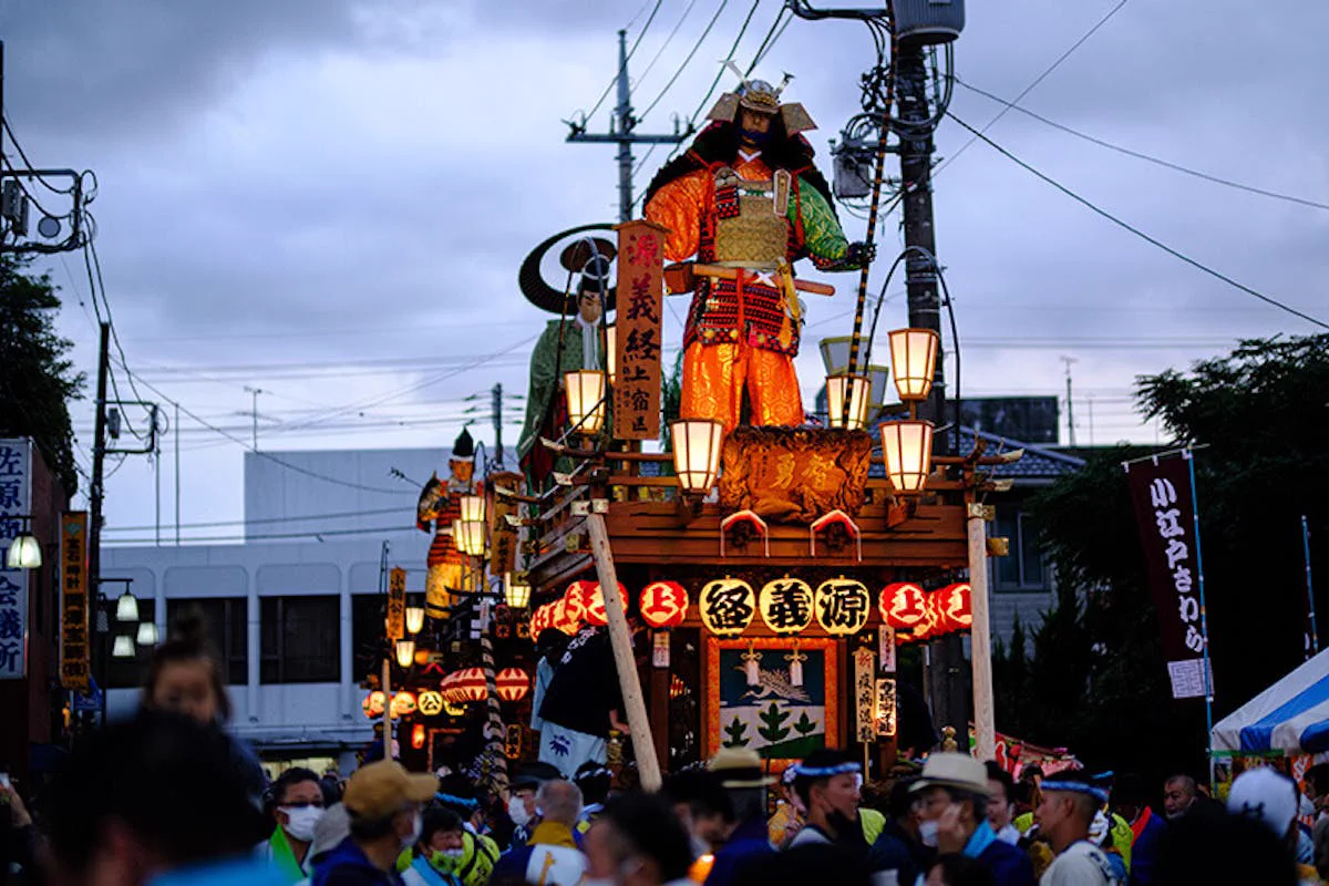 Large samurai doll float illuminated at dusk during Sawara Grand Festival Autumn