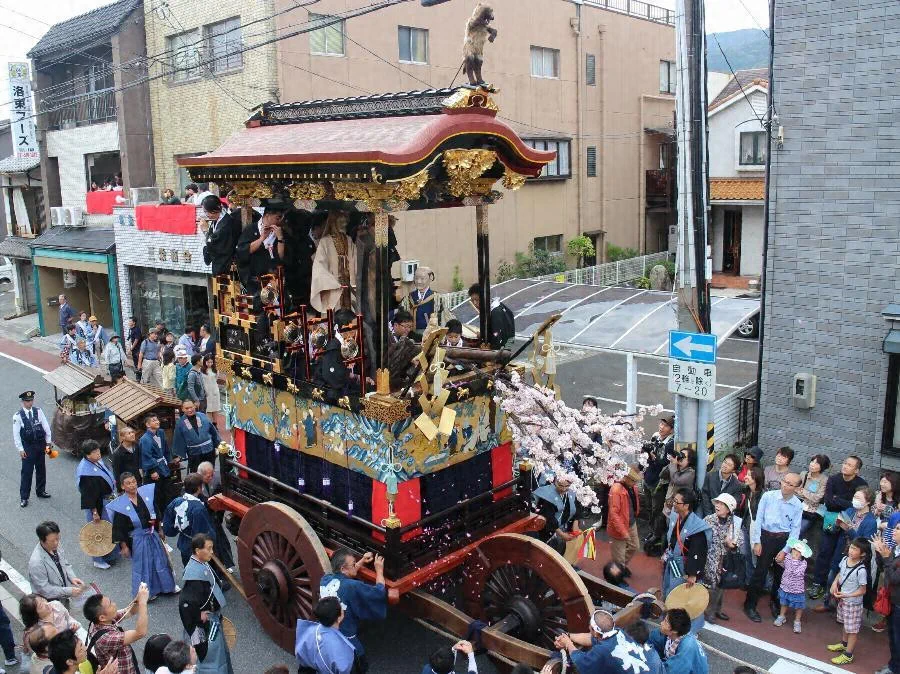 Historic Otsu Matsuri hikiyama moving through the city with spectators lining the street