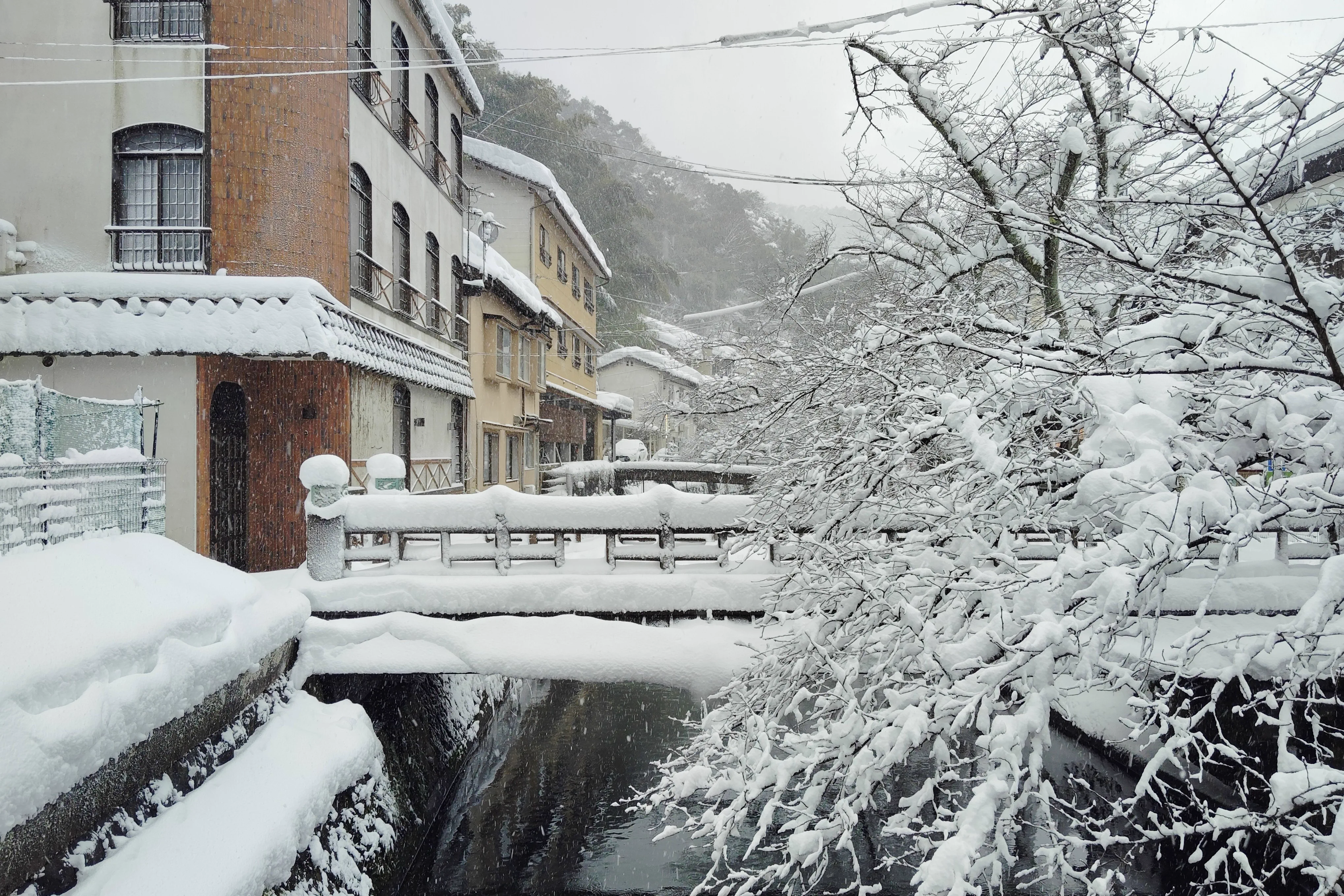 Otani River through Kinosaki Onsen, showing the compact town layout between ryokans and bathhouses