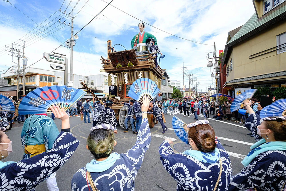 Festival team pulling a traditional Sawara float through the streets during the autumn festival