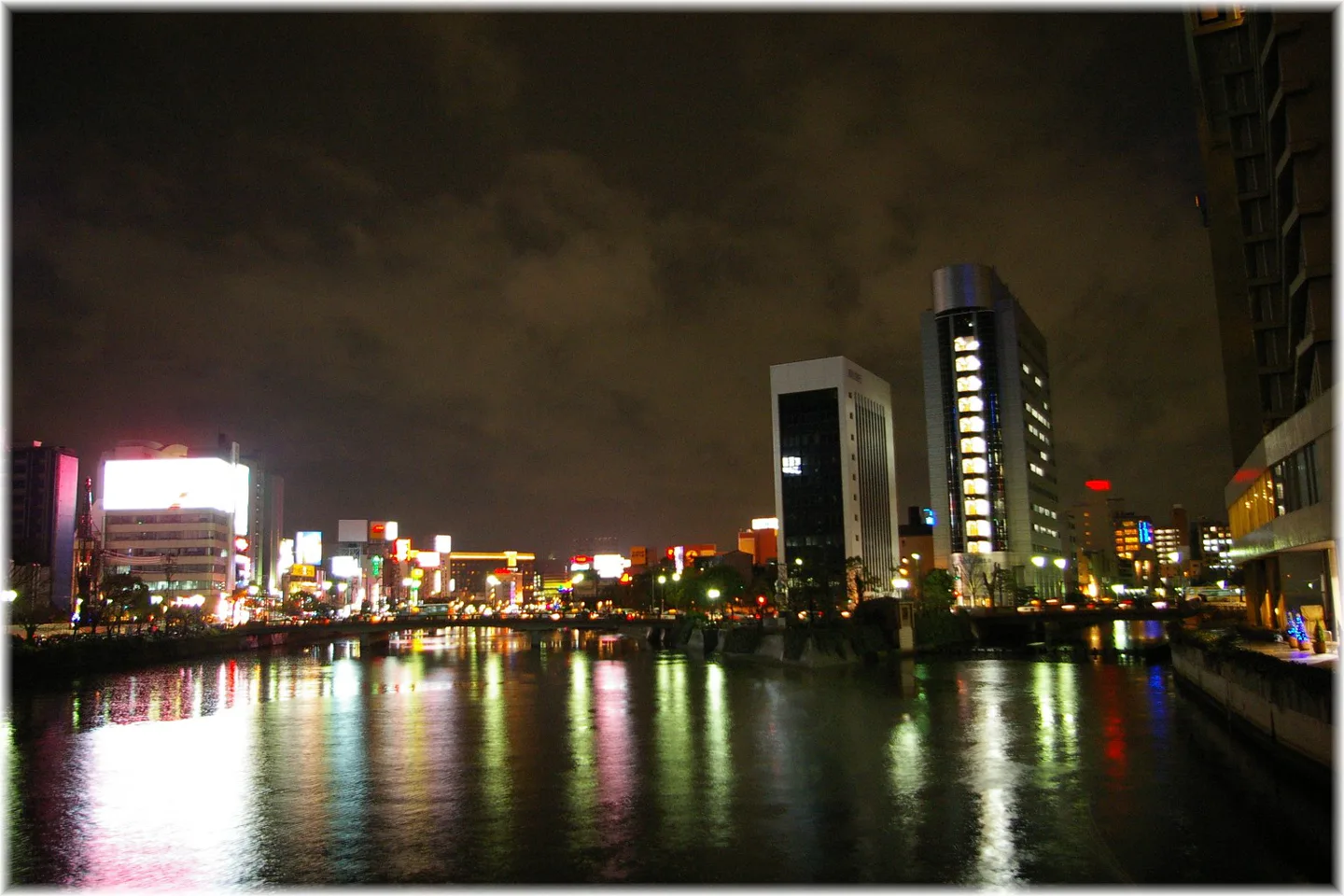 Nakasu riverfront at night for pairing the cruise with dinner or yatai afterward
