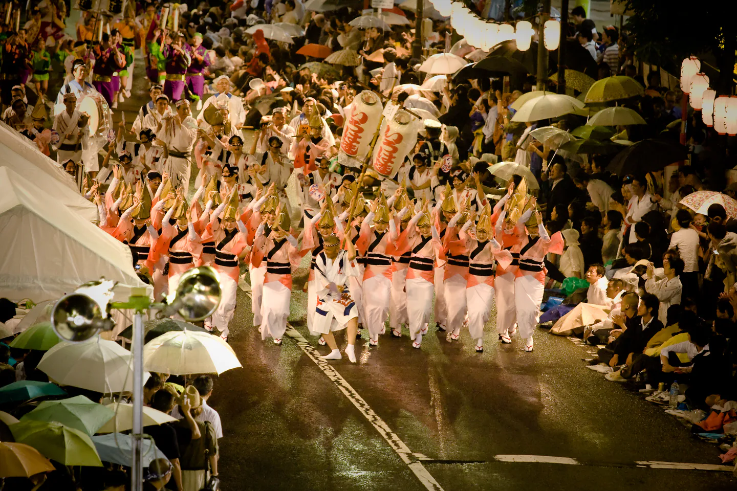 Koenji Awa Odori dancers moving through the street as spectators watch